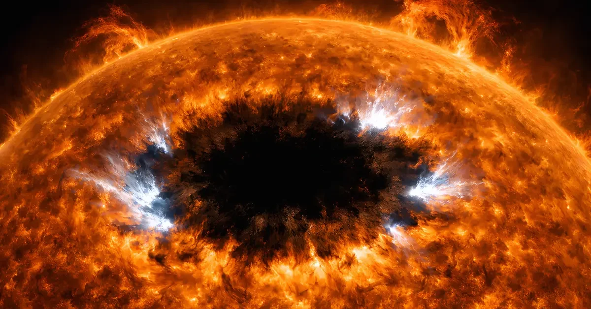 Massive sunspot AR4366 on the sun's surface with bright solar flares erupting from its edges, shown in high-contrast hydrogen-alpha telescope view.