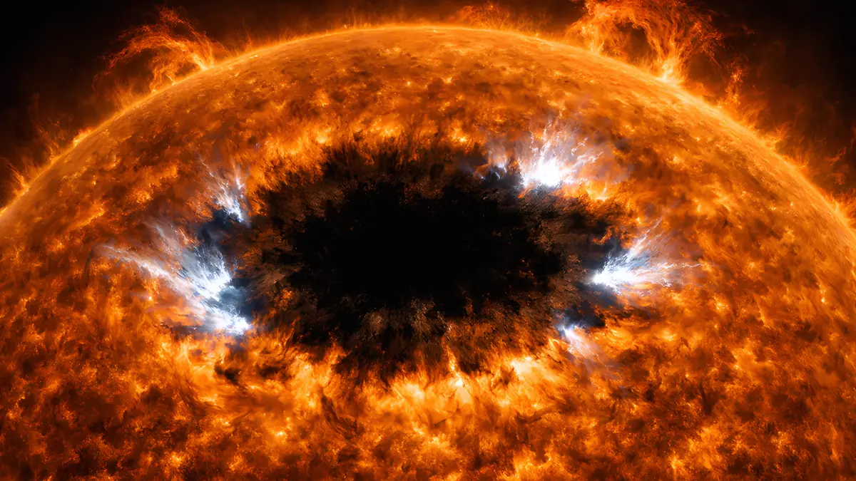 Massive sunspot AR4366 on the sun's surface with bright solar flares erupting from its edges, shown in high-contrast hydrogen-alpha telescope view.