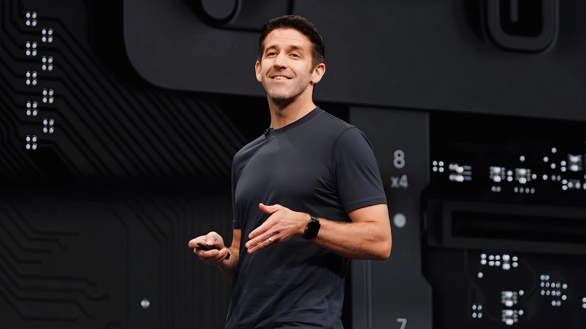 A professional male tech executive standing in a modern corporate office, representing the future leadership of a major technology company.