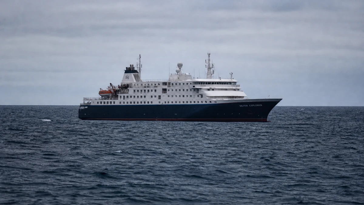 The MV Hondius expedition cruise ship anchored in the Atlantic Ocean under overcast skies.